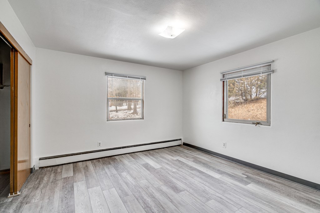 A room with a window and a door.