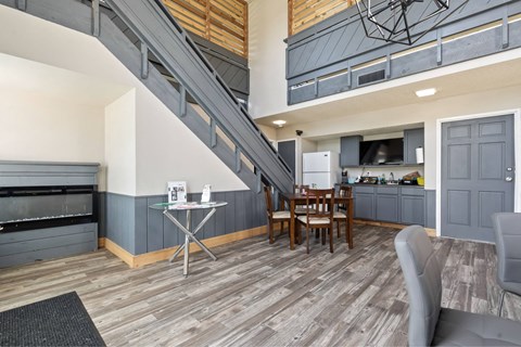 A living room with a grey couch and a wooden floor.