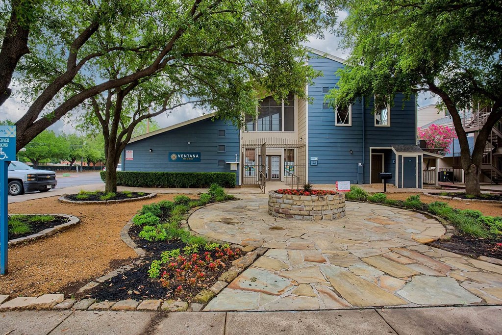 A blue building with a stone walkway in front.