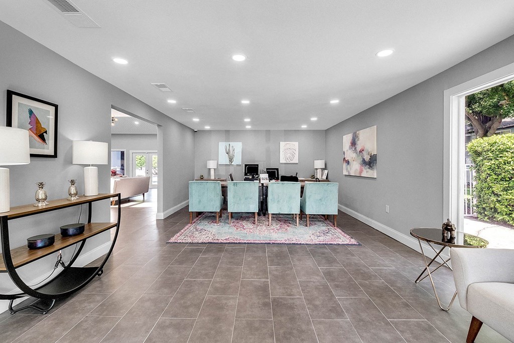 A modern dining room with a long table and chairs.