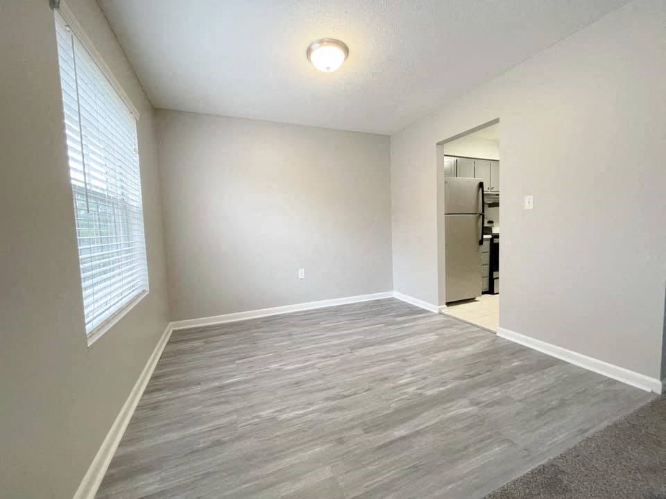 A room with a grey floor and a white door.