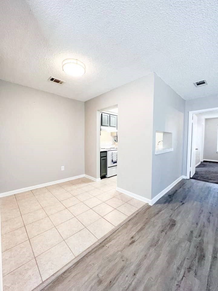 A room with a white ceiling and a wooden floor.