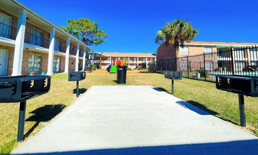 A sunny day at the apartment complex with a clear blue sky.