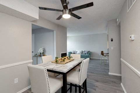 A dining room with a table set for two.