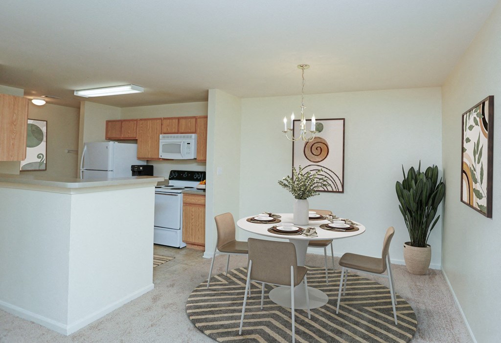 A kitchen with a dining table and chairs.