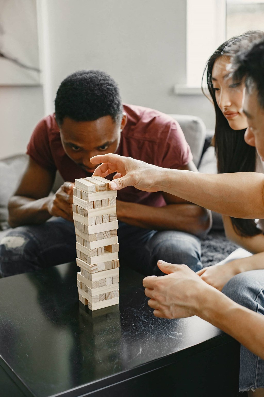 A man and woman playing a game of Jenga.