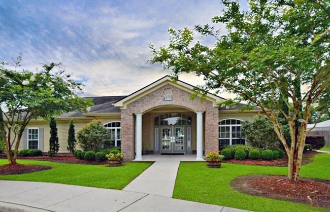 A house with a front yard and a tree.