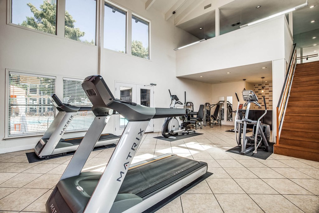 A treadmill with the brand name "NAATRIX" on it is in a room with other treadmills and exercise equipment.