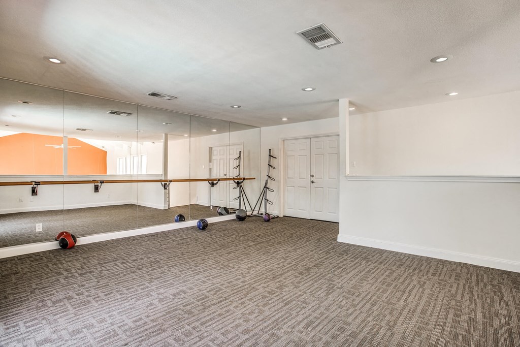 A room with a grey carpet and a white ceiling.