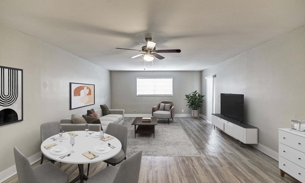 A living room with a dining table set for six.