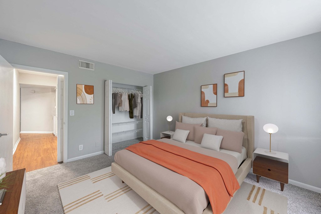 A bedroom with a bed, nightstand, and a rug.