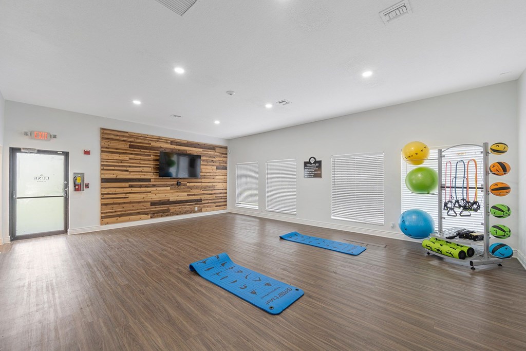 A room with a wooden wall and a TV on it.