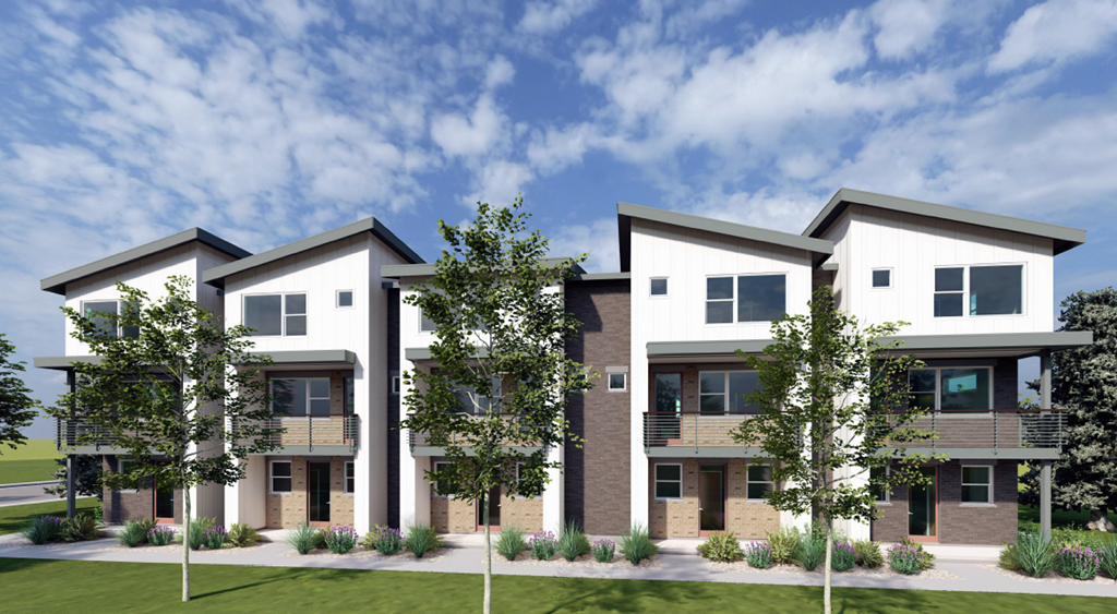A modern three-story residential building with a green lawn in front.