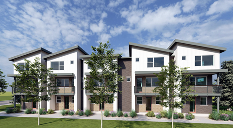 A modern three-story residential building with a green lawn in front.