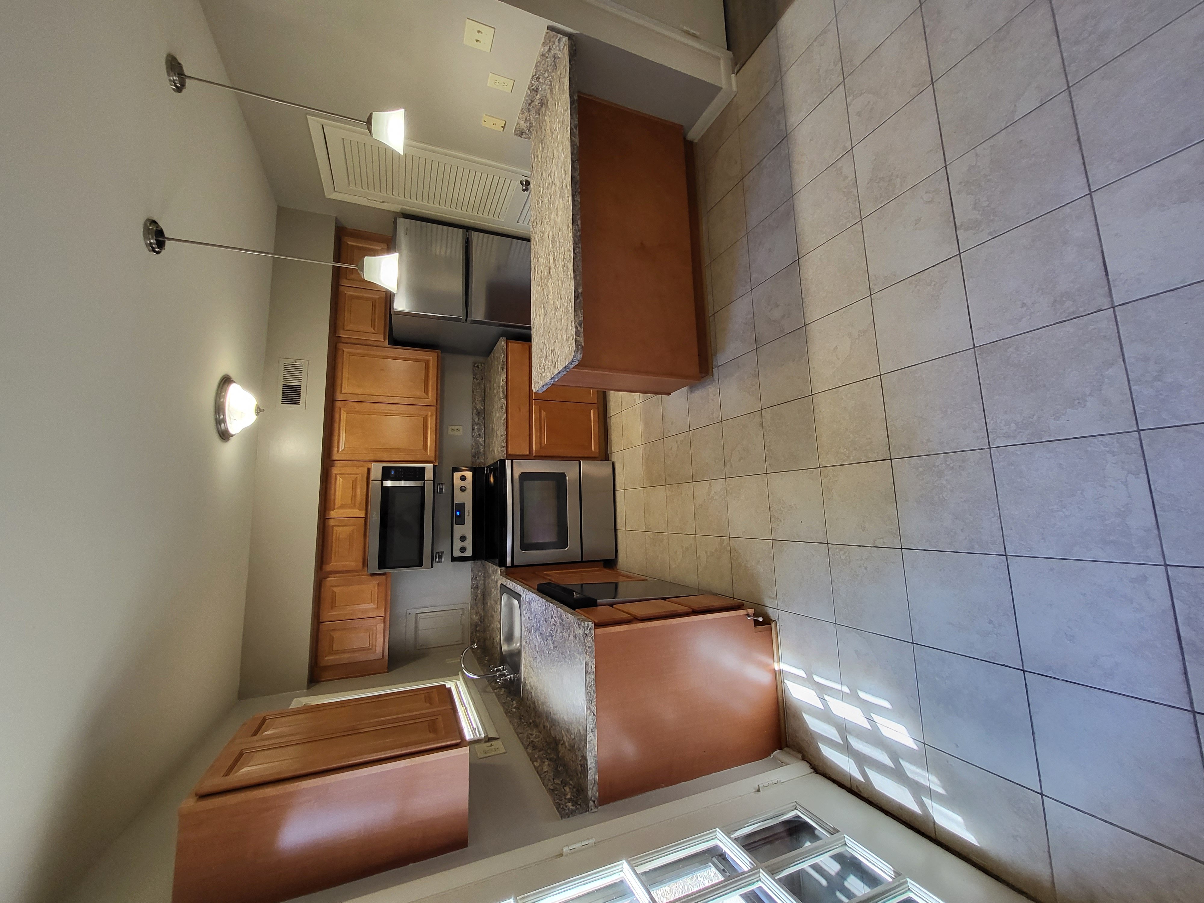 an overhead view of a kitchen with brown cabinets and a counter