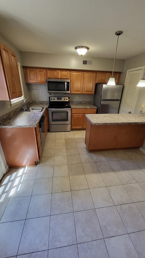 an overhead view of a kitchen with brown cabinets and a counter