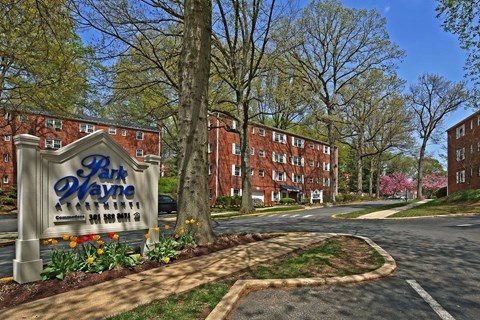 A sign for Park Hayne stands in front of a building.