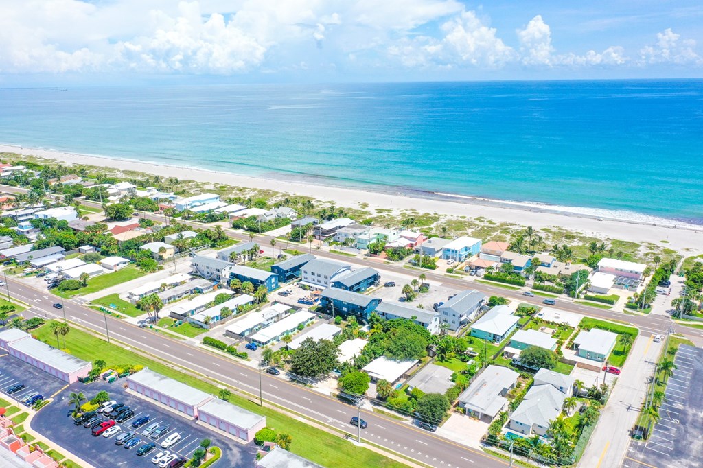 A beachfront community with a parking lot in the foreground.