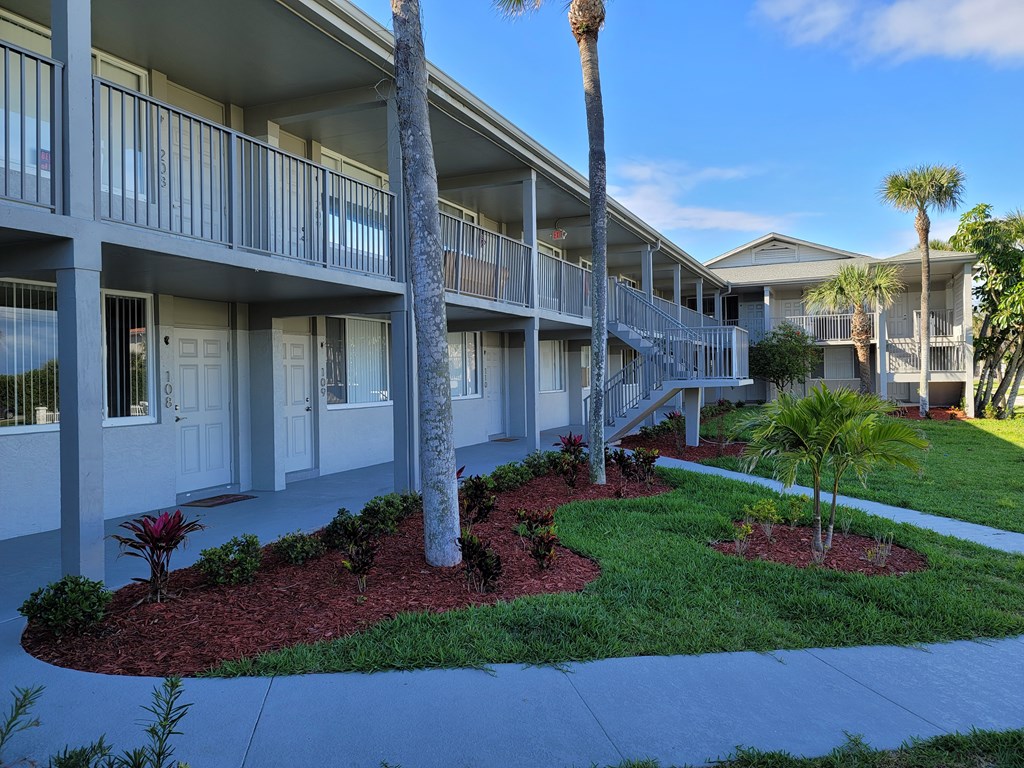 A sunny day at the apartment complex with a clear blue sky.