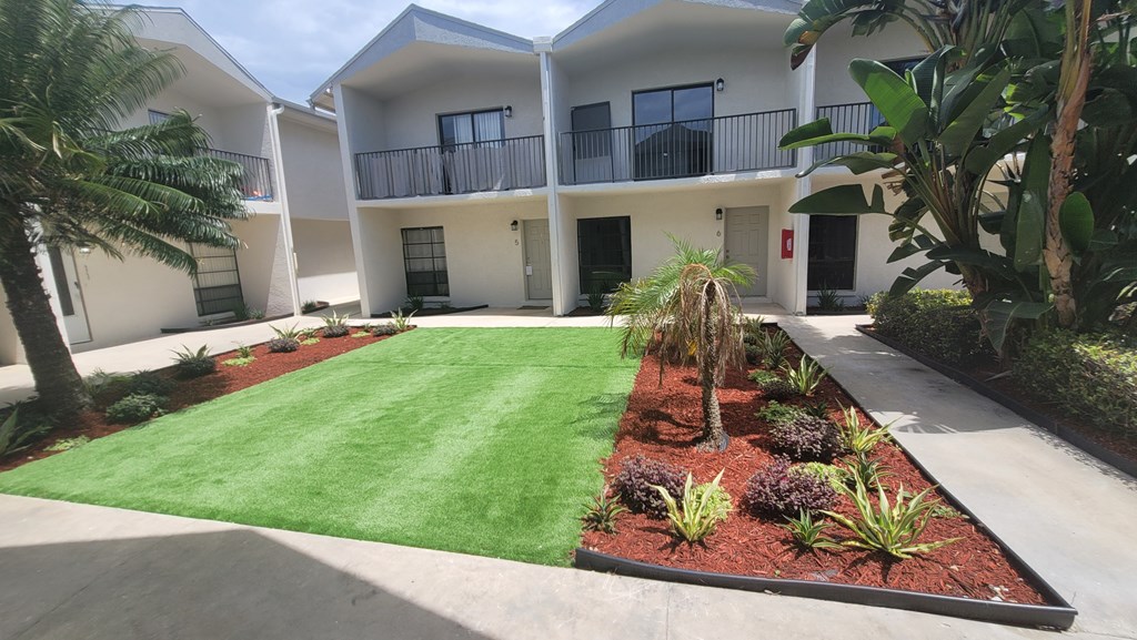 A modern house with a well-maintained garden in front.