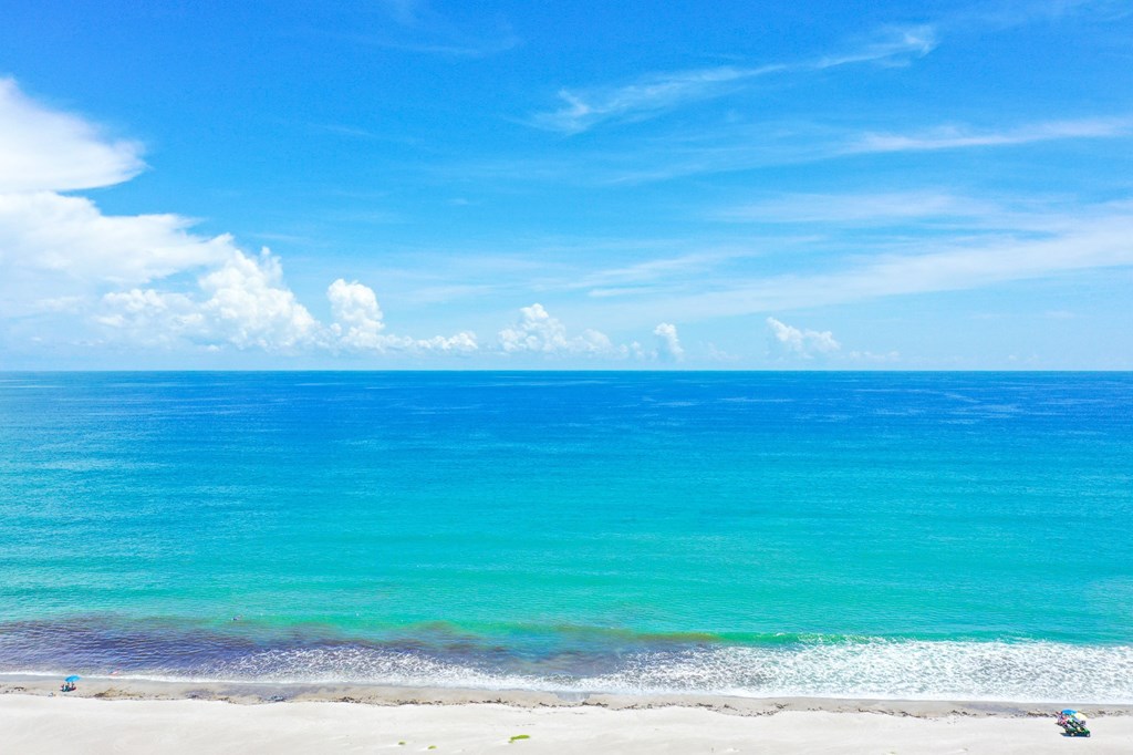 A beautiful beach with white sand and blue water.