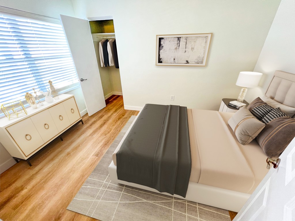 A bedroom with a bed, nightstand, and a dresser with a mirror.