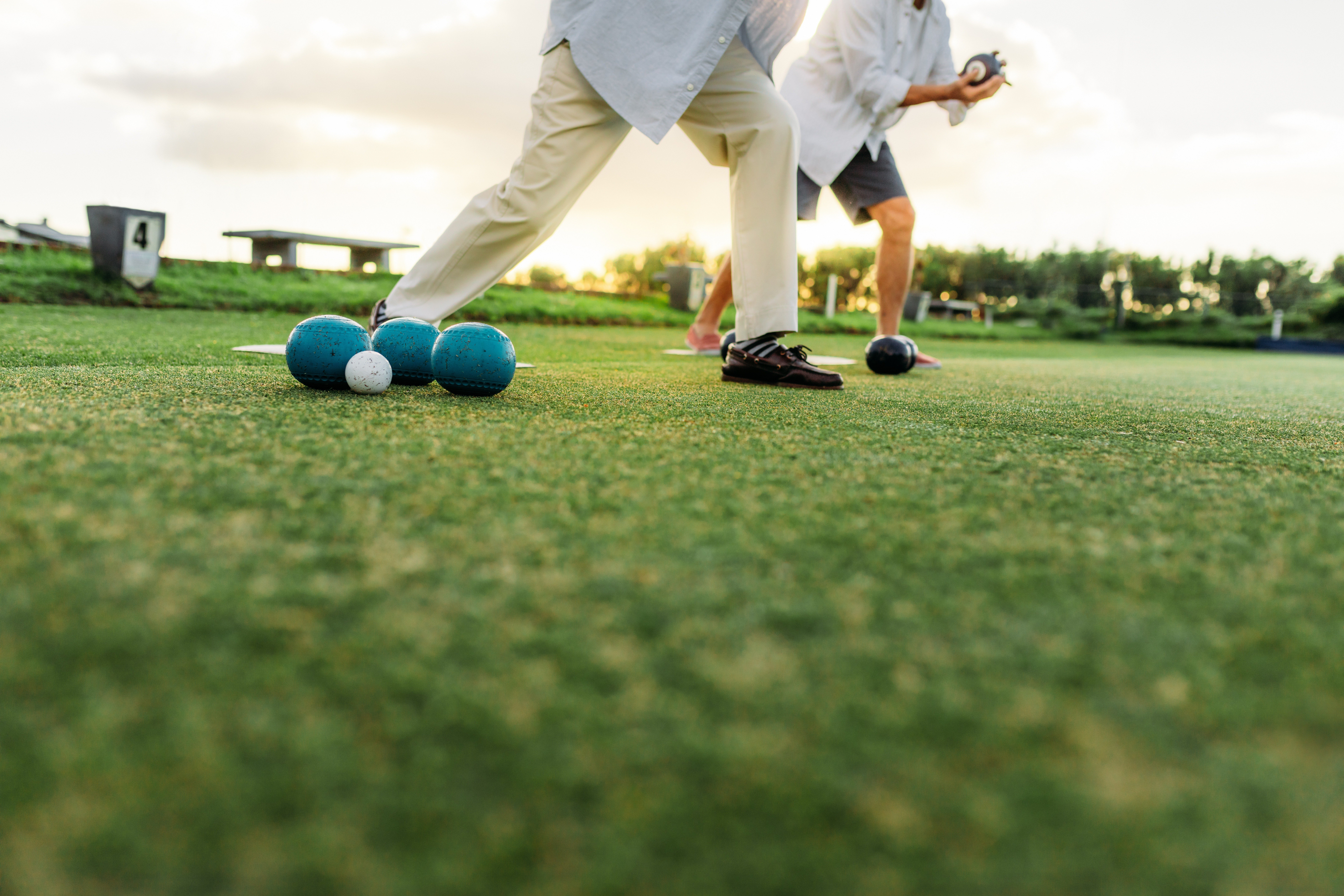 A man is playing golf on a sunny day.