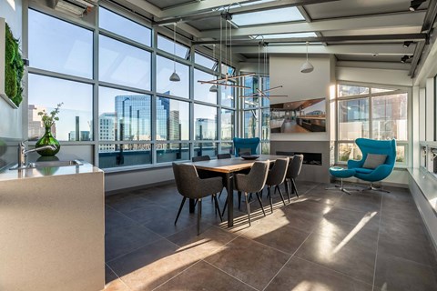 A modern dining room with a long table and chairs.