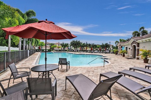 Community pool with chase lounges and dining furniture.
