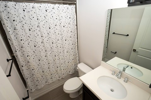 A white toilet sits next to a sink in a small bathroom.