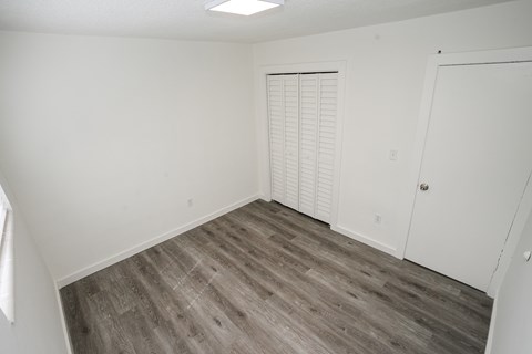 A room with a wooden floor and white walls.