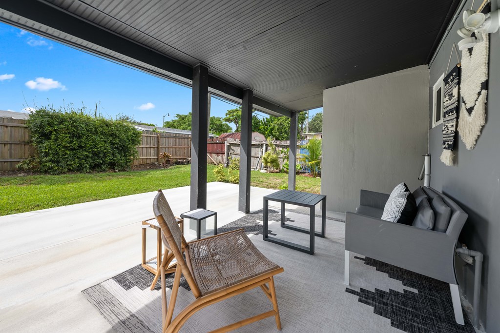 A patio with a chair and a table.