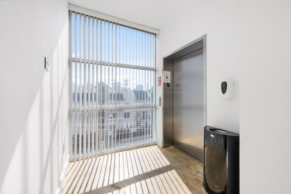 A modern room with a glass door leading to a balcony.