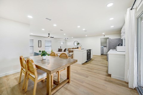 A modern kitchen with a dining table and chairs.