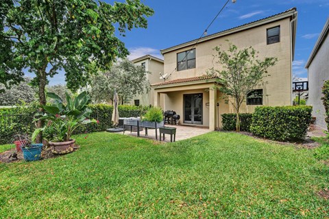 A house with a green lawn and a patio.