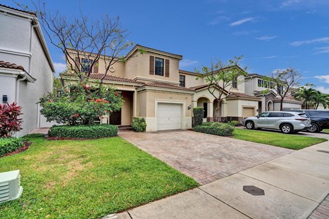Home street view with off-street visitor parking.