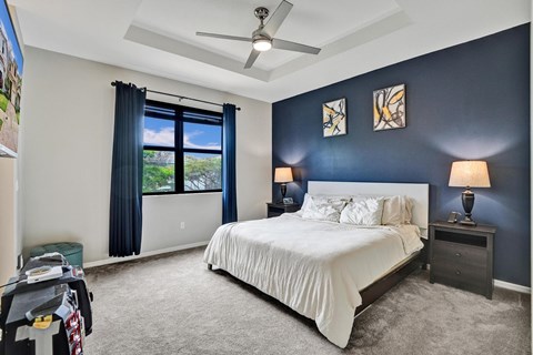 Master bedroom with garden view, accent wall and artwork.