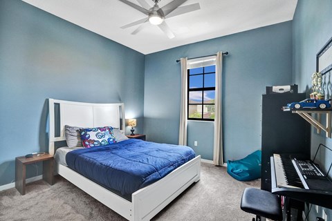 Child room with garden view, bright natural light and ceiling fan.