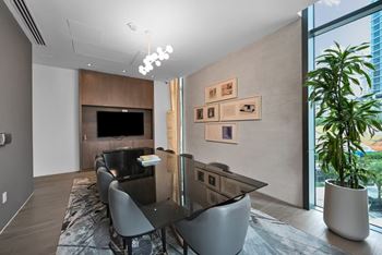 A modern living room with a black table and chairs.
