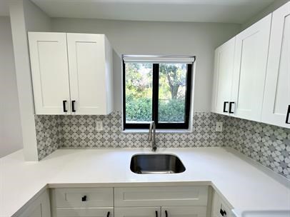 A kitchen with a sink and cabinets.