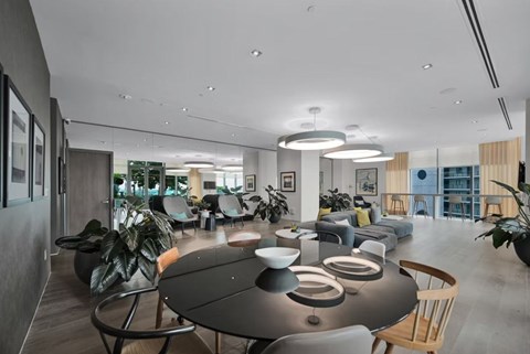 A modern dining area with a long table and chairs.