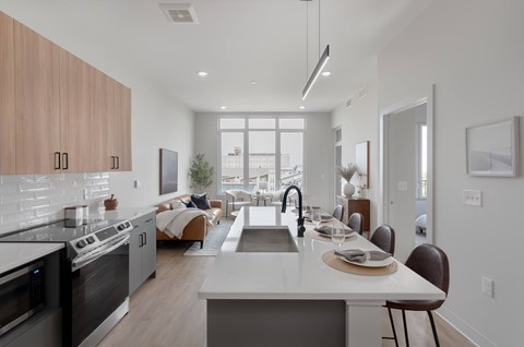 A modern kitchen with a large island and stainless steel appliances.