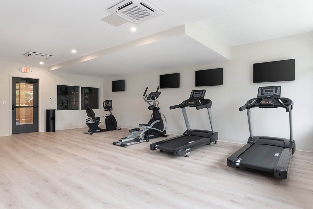 A gym with treadmills and exercise bikes.