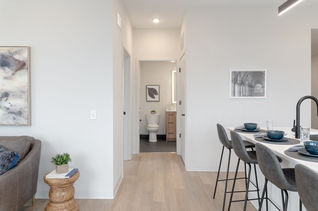 A modern dining room with a table set for two.