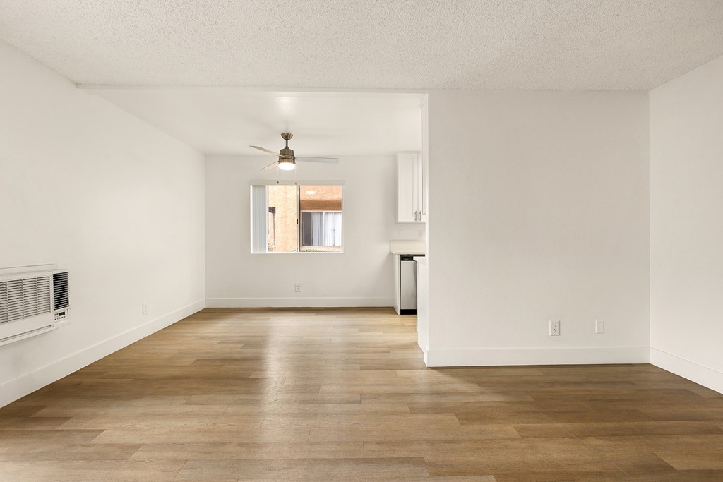 A room with a ceiling fan and a window.