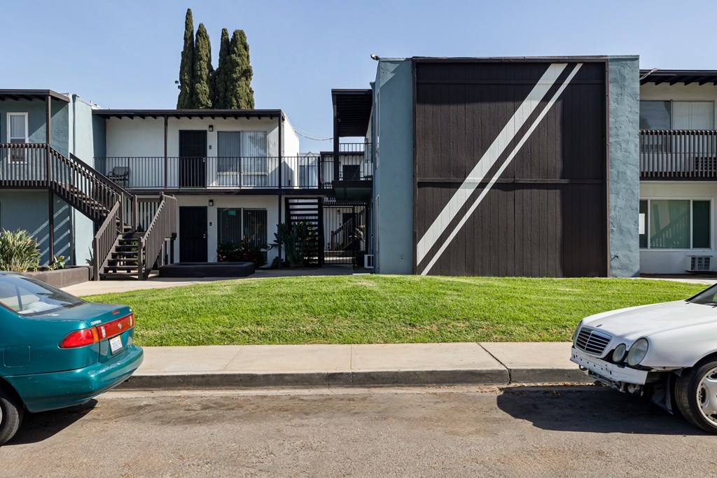 A green car is parked on the left side of the street.