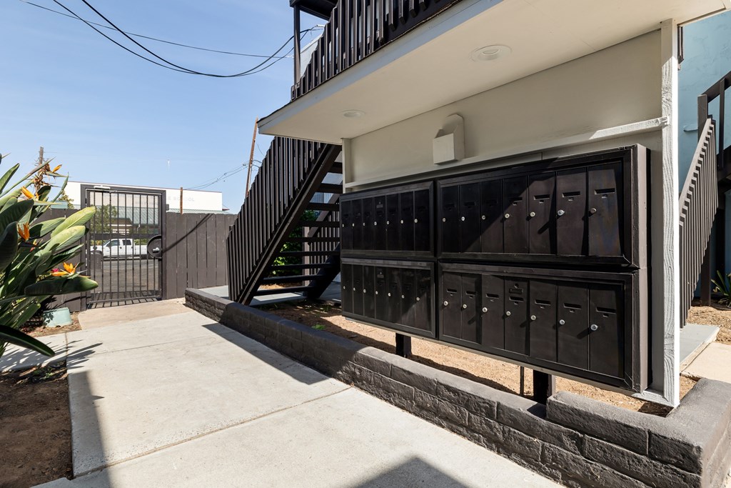 A black metal gate with a white door is closed.