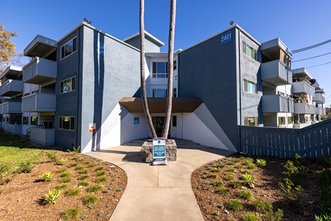 A modern building with a blue sign that reads