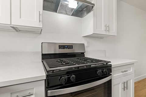 A modern kitchen with a black stove top oven.