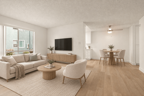 A living room with a couch, chairs, and a television.